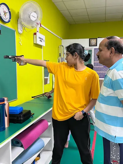 Our head coach, Manjunath Patagar, provides one-on-one guidance to a shooter. This focused training helped her set a new record and win two gold medals at the South Zone Shooting Competition.