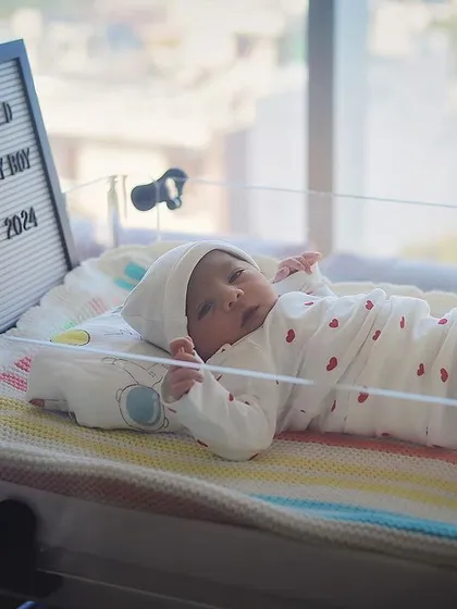 "Hello World!" This little one is announced with a cute letter board next to their hospital bassinet. It's a sweet way to remember their birth date and celebrate their arrival.