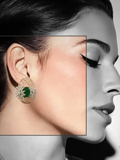 A creative shot emphasizing the colour and form of our emerald and diamond stud earrings against a black and white background.