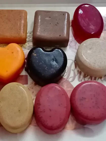 A beautiful assortment of my herbal soaps in various shapes, colors, and formulations, including coffee, charcoal, and red wine.