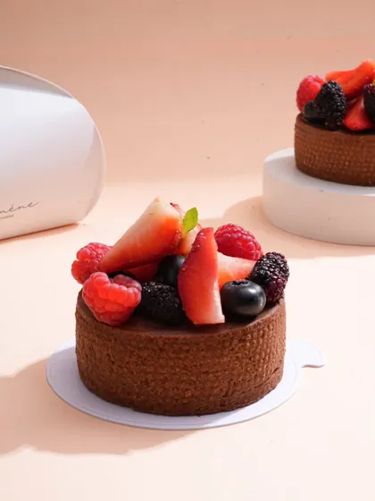 A close-up of a beautiful berry tart, shot with soft lighting to emphasize the fresh fruit and delicate pastry. This style of dessert photography is perfect for high-end patisseries and bakeries.