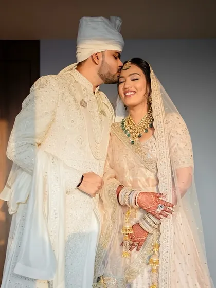 The elegance of an ivory lehenga is timeless. This look is all about soft, romantic beauty, capturing a moment of pure joy and grace for the bride and groom. 🤍