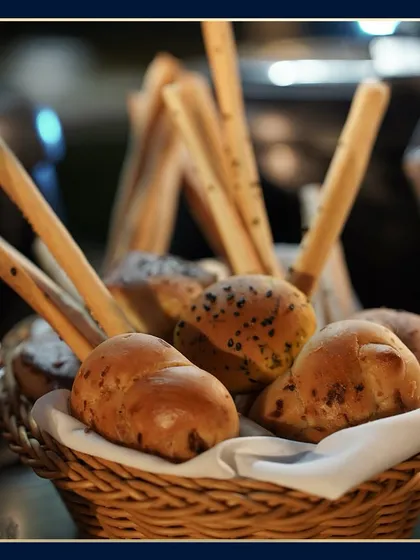 Even the simplest items are presented with care. A basket of freshly baked artisanal breads and breadsticks, ready to accompany the main meal at one of our catered events.
