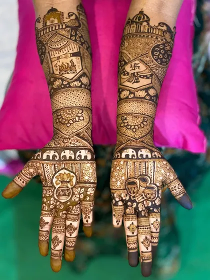 This design is packed with auspicious symbols, including the sacred fire, swastika, kalash, and Ganpati, for a truly blessed bridal look.