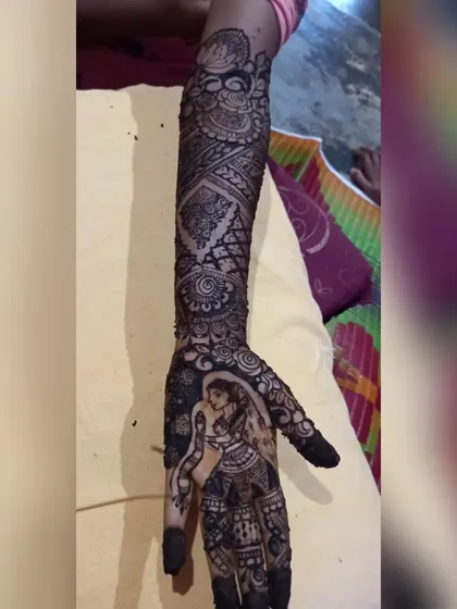 A clear shot of the bride portrait on one arm, showing the rich color and the intricate patterns surrounding it.