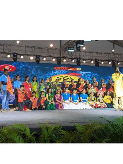A group photo on stage with the organizers and singer at the Karavali Utsav.