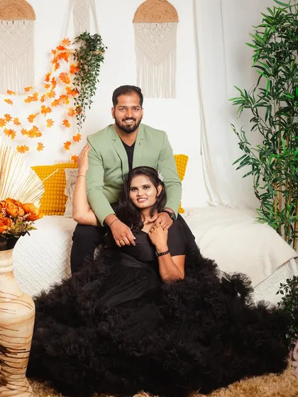 A fun and intimate pose from a couple's shoot. The dramatic black ruffled gown adds a touch of glamour to this relaxed and happy moment in our boho themed studio.