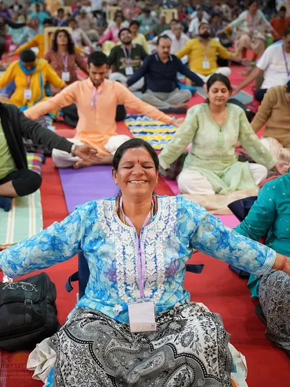The goal of our practices is a joy that bubbles up from within. This participant's smile during a session on the Patanjali Yoga Sutras captures the happiness and sense of release that comes from connecting with deep wisdom and meditation.