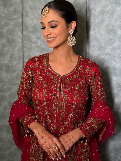 A smiling shot of this maroon mood, showing how the soft glam makeup looks both elegant and joyful. The focus is on the eyes and the flawless skin.