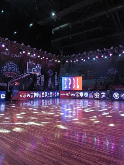 The main court is prepared for an EP3L game, with team logos displayed on the sideline LED screens. This professional setup is part of the daily environment at our academy.