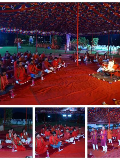 A wide shot of the Fire Meditation event, showing all participants dressed in red, seated on the ground, creating a vibrant and unified field of energy.