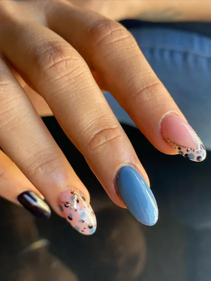 A detailed shot of the mixed pattern nails. You can see the different textures and finishes, from the glossy solid colors to the glitter and polka dots.