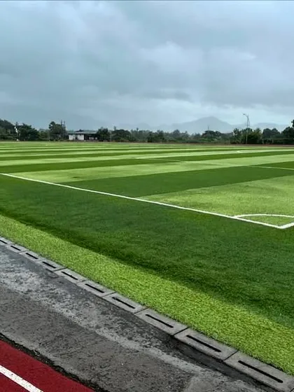 The view from the athletics track overlooking our FIFA-standard football pitch at the Corvuss campus. This image showcases the scale and quality of the integrated sports infrastructure available to our student-athletes.