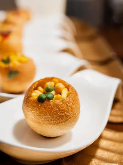 A close-up of our deconstructed golgappa canapés, served in elegant spoon-shaped dishes for a modern twist on a classic.