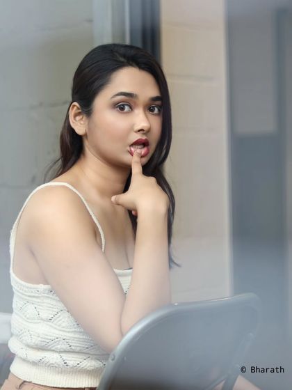 A playful and intimate portrait, shot through a window for a creative framing effect.