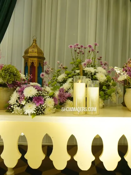 An elegant console table arrangement with a mix of florals and lanterns, creating a beautiful decorative corner.