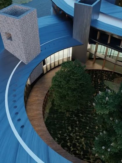 A close-up aerial view of the circular building concept. The design features a curved walkway and stone-clad towers, demonstrating our exploration of unconventional forms that harmonize with nature.