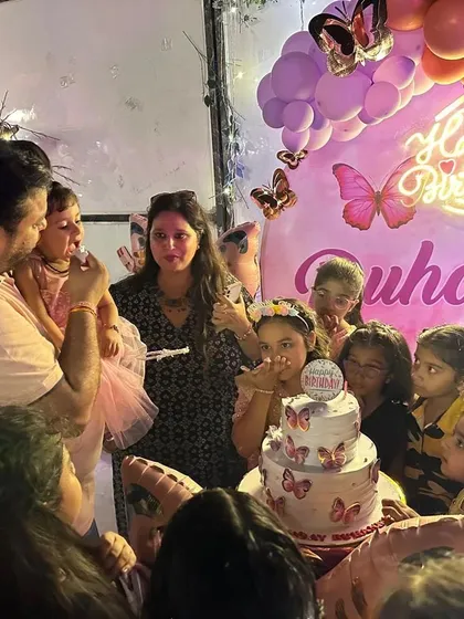 A candid moment of the cake-cutting ceremony, surrounded by friends and family. My decor provides the perfect backdrop for these precious memories.