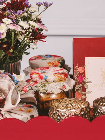 Let your gifts speak the language of love and light this Diwali. Our artisanal hampers, like this one in a festive red tray, are crafted to share joy with family and friends.