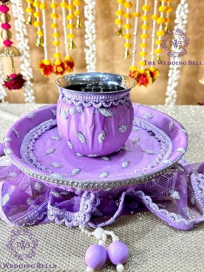 The base of our lavender thali set, showing the intricate fabric work and matching thaal cover.
