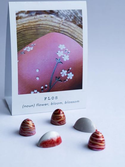 "Flos," or flower. These delicate bonbons are designed to look like blossoms, combining intricate patterns with floral-infused ganaches.