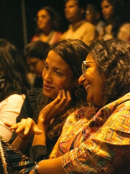 Audience members sharing a smile during a ghazal night. It's these moments of shared joy that make it all worthwhile.