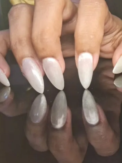 A different angle of the pearly white nails, showing their cat-eye-like shimmer.