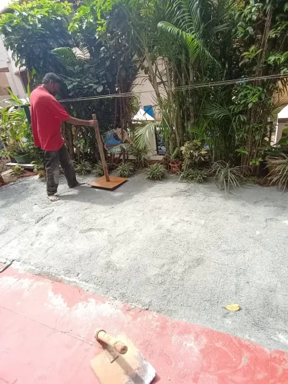 Leveling the base material is a critical step for a professional artificial turf installation. This ensures the final surface is even and drains properly.