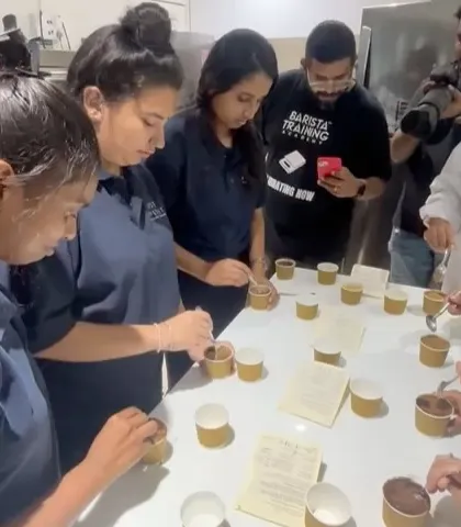 Students from Just Appetite culinary school participating in a coffee appreciation session. Here, they are learning the formal process of cupping.