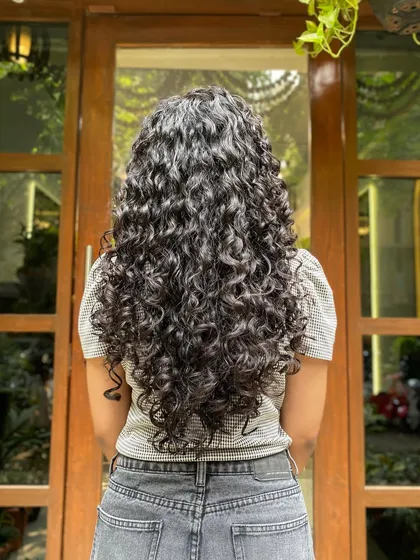 This client had beautiful length, but her curls were hidden. A proper dry cut and styling routine revealed these stunning, hydrated, and perfectly spiraled long curls.