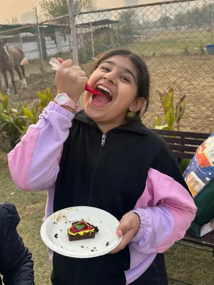 The best part of decorating is eating the results. A child happily enjoys her Christmas treat.