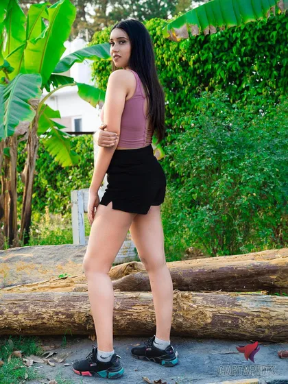 A full-body shot showcasing an athleisure look in a natural, outdoor setting. The composition uses the environment to frame the model, making it suitable for fitness apparel brands or a model's commercial portfolio.