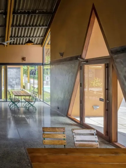 The interior of Teyla features unique triangular windows and doors, adding a geometric design element that complements the building's angular roofline.