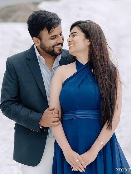 A happy portrait of Harshit and Kritika, their smiles warm against the cold, snowy landscape of Gulmarg.
