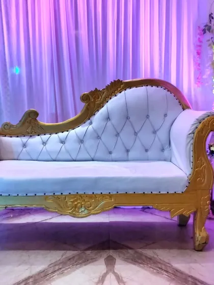 A close-up of the ornate white and gold wedding diwan we provide for rent, perfect for adding a touch of royalty to your stage.