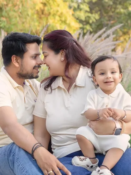 A sweet, romantic moment between parents while their son smiles for the camera. Outdoor sessions allow for a beautiful mix of candid and posed shots.