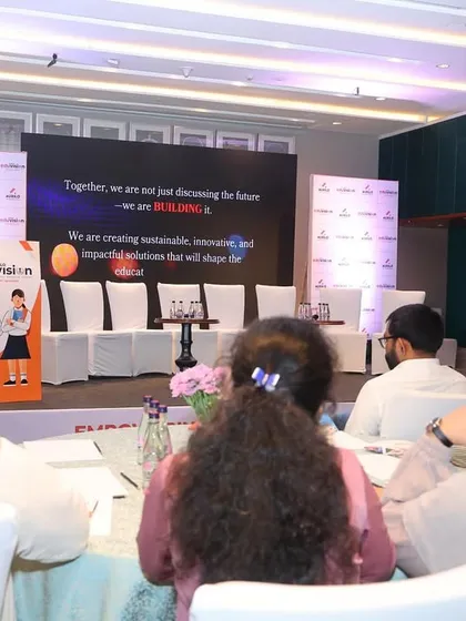 A view from the audience at the educational conference, showing the intimate and focused setup.