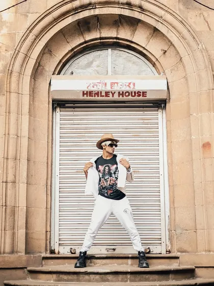 A reveal shot from the themed shoot, showing the graphic tee under the jacket.