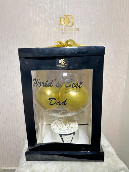 The full view of the tuxedo cake and balloon hamper, presented in a sleek black display box.