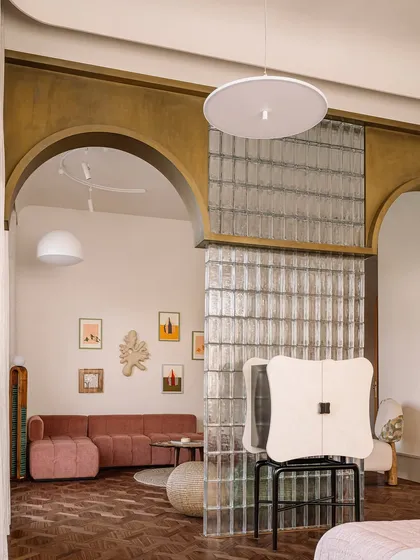 This image captures a collection of our unique seating and table designs. From a plush, channel-tufted sofa to a sculptural lounge chair made of upholstered stone, each piece is designed to be a work of art.