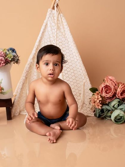 Another perspective of the boho-themed baby shoot. This shot captures the baby's curious expression as he sits in the beautifully styled set.