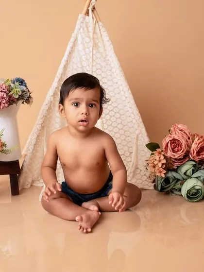 Another angle from the boho-themed baby shoot, showing the full setup with the teepee and floral arrangements.
