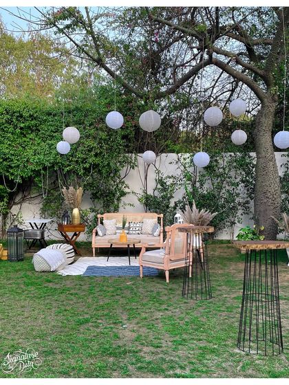 A wider angle of the garden party setup, showing how I arrange different zones for lounging, dining, and drinks to create a functional and flowing event space.