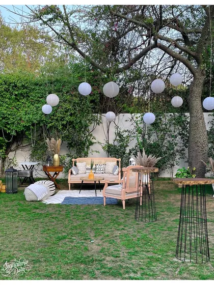 A wider angle of the garden party setup, showing how I arrange different zones for lounging, dining, and drinks to create a functional and flowing event space.