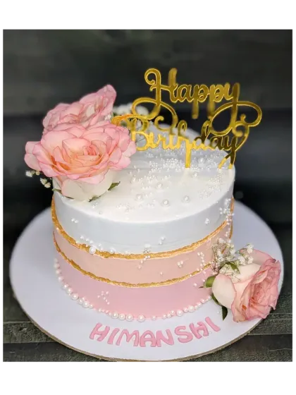 A beautiful pink and white ombre cake for a wife's birthday. This fresh pineapple cake is decorated with fresh roses and has a delicate, torn-edge gold accent.