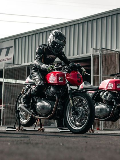 A rider on a GT 650 on a paddock stand in the pit lane.