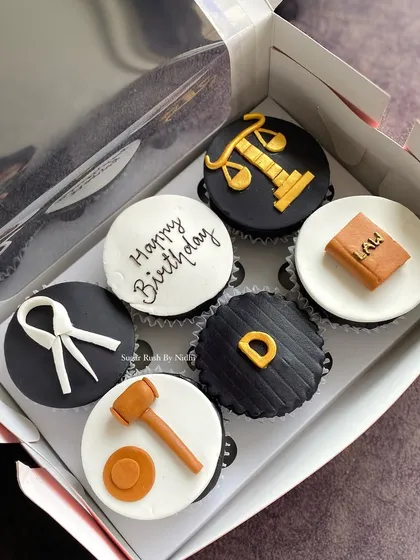 A set of custom cupcakes I made for a lawyer's birthday, complete with fondant gavels, scales of justice, and law books.