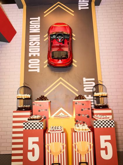 The dessert station was cleverly designed as a pit stop, with a car mounted on the wall and treats displayed on tiered platforms.