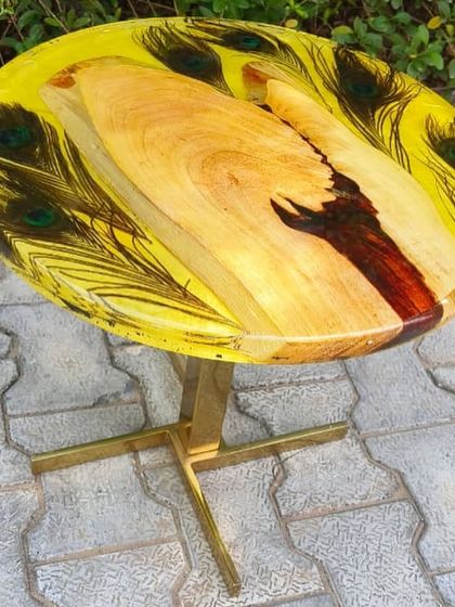 This vibrant table with embedded peacock feathers was made during one of my exclusive workshops. I teach students how to work with delicate materials like feathers.