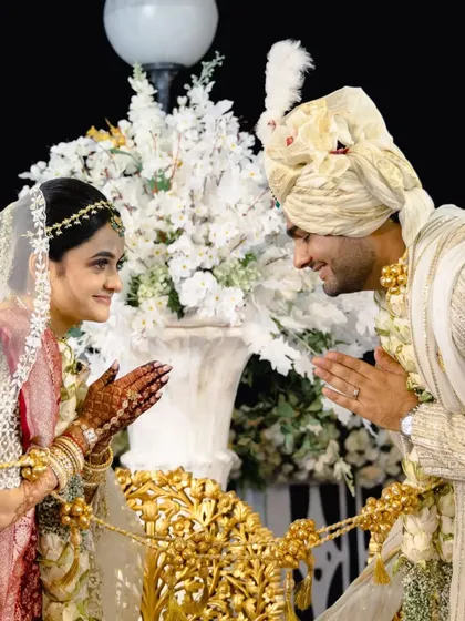 A traditional greeting between the bride and groom, a sign of the respectful partnership they are about to begin.